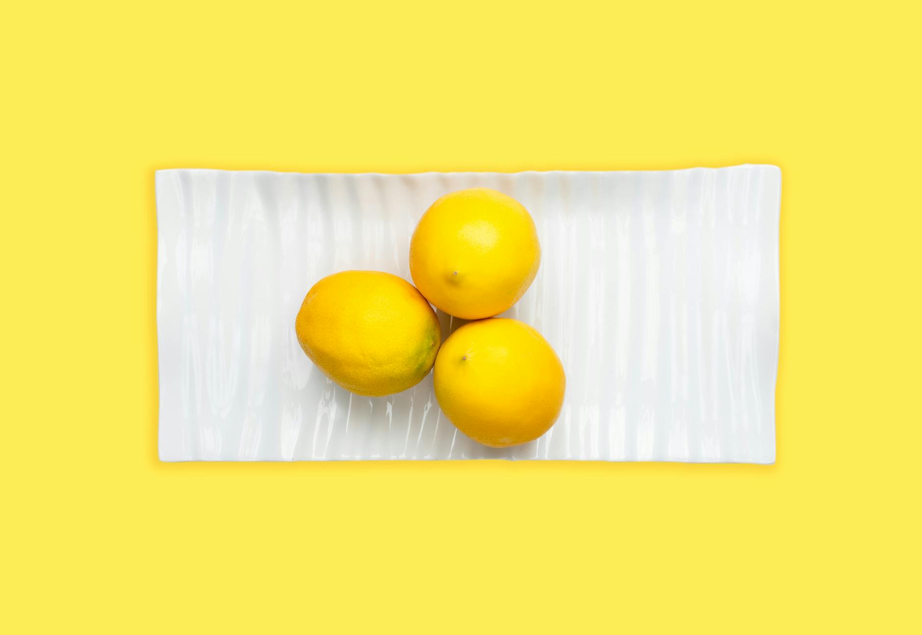Fresh lemons arranged on a white plate, symbolizing the natural approach to PCOS and sexual health