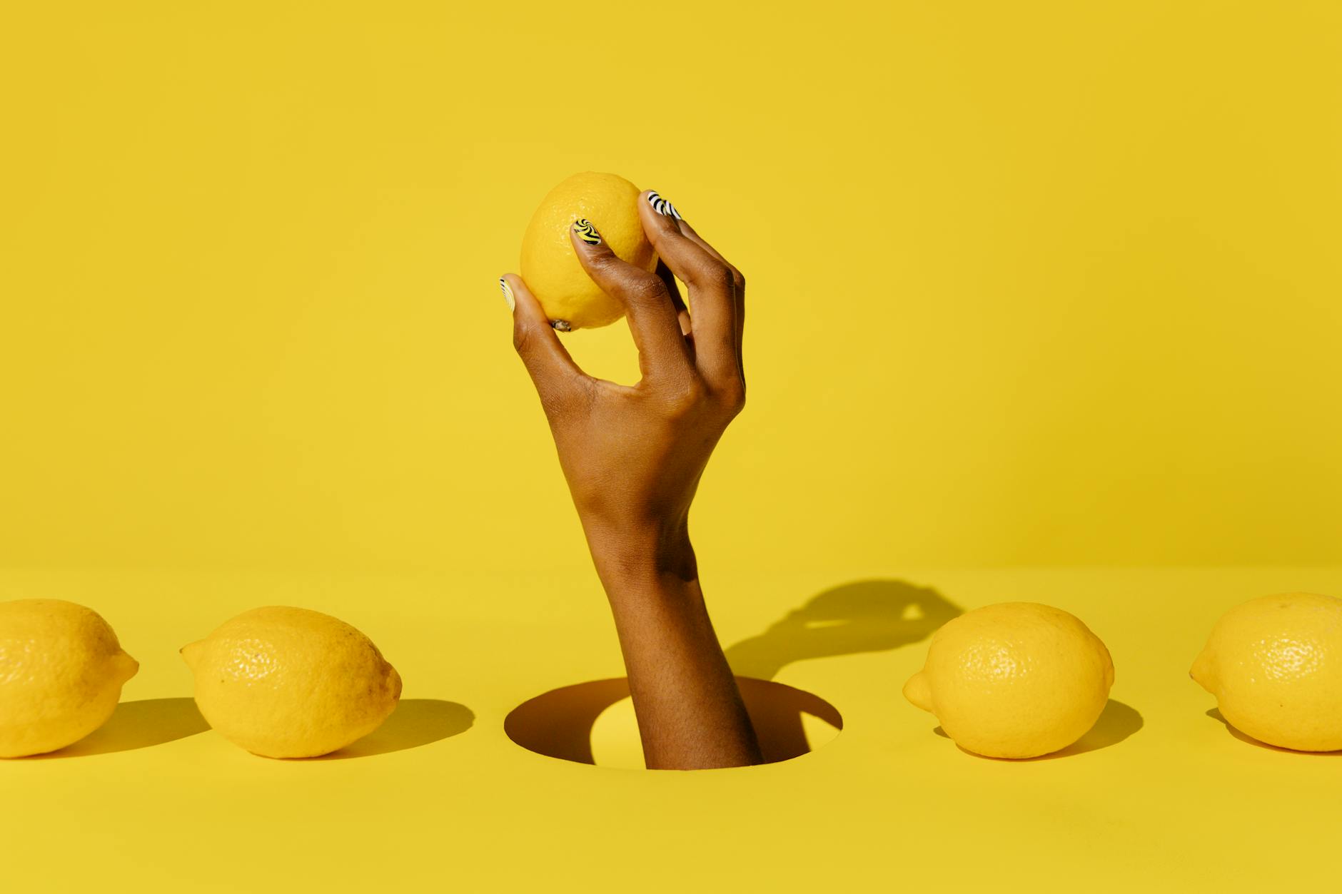 Yellow silicone vibrator with fresh produce on bright background